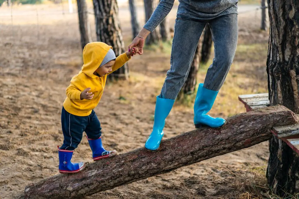 baby walking on log