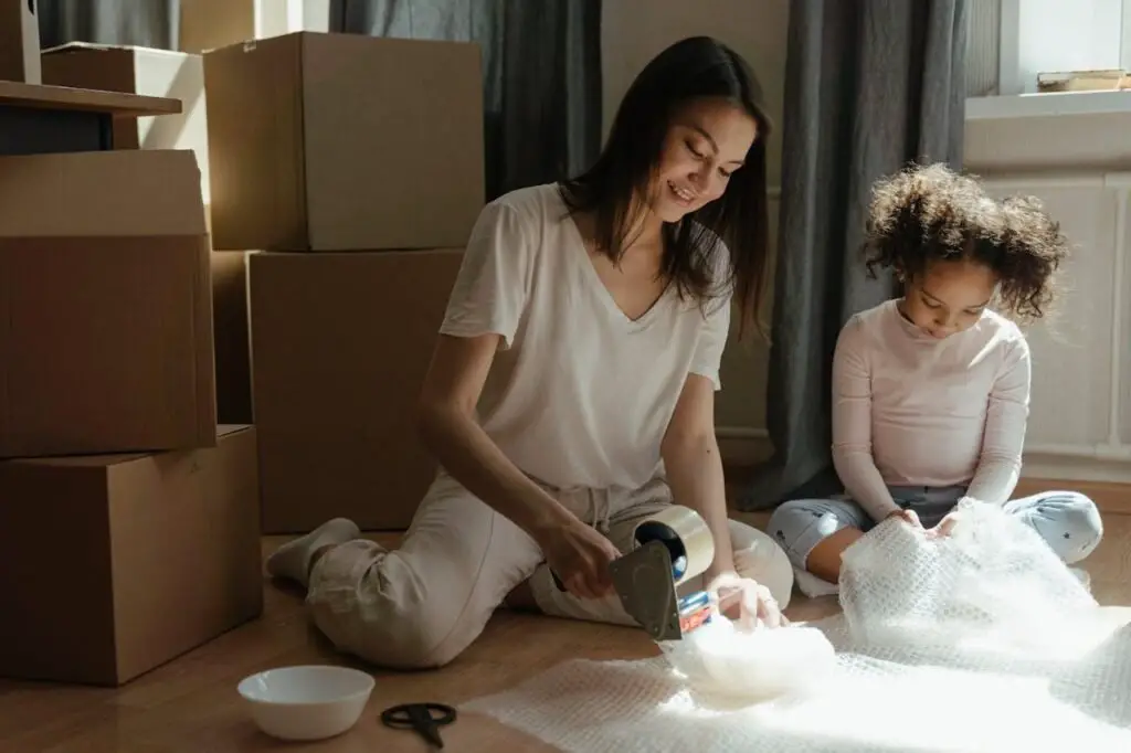 Mom packing for the move with a kid